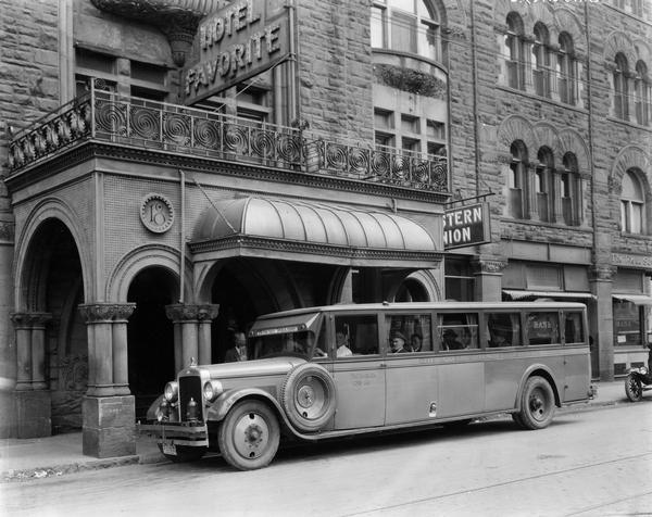 International Model 52 or 53 motor coach picking up passengers at the Hotel Favorite in downtown Dayton. The bus was owned and operated by the Inter Cities Coach Co.