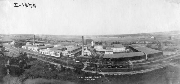 Wide angle elevated view of the St. Paul Flax and Twine Mill. The factory was owned and operated by an International Harvester subsidiary called the International Flax Twine Company (originally Minnie Harvester Company). The factory produced binder twine.
