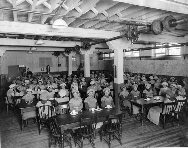 Female employees assembled in the cafeteria at International Harvester's Osborne Works. The factory was located at 5 Pulaski Street and was owned by the D.M. Osborne Company until Osborne was purchased by International Harvester in 1903.