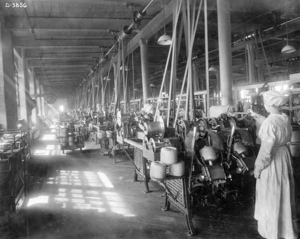 Female workers using machines to ball twine at International Harvester's Deering Works twine mill. The Deering works was located at Fullerton and Clybourn Avenues. It was owned and operated by the Deering Harvester Company from 1880 until the formation of International Harvester in 1902.