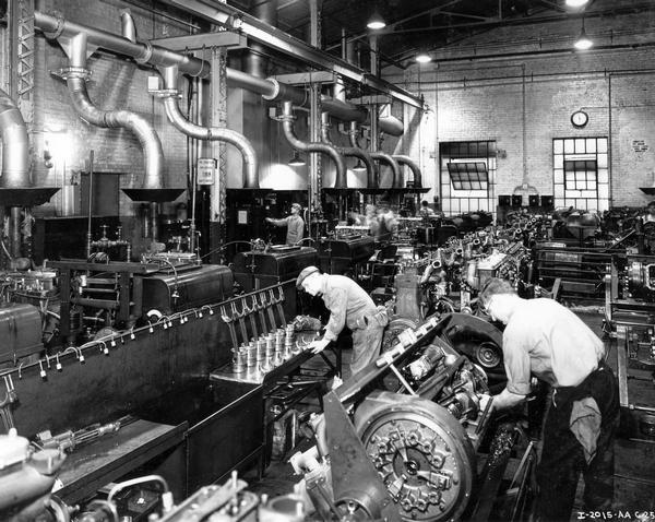 Workers at International Harvester's Milwaukee Works perform "tear-down" inspections and tests of diesel engines.