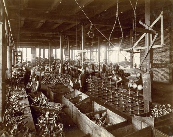 Workers assembling disc harrows at in the "erecting room" of International Harvester's Hamilton Works at Hamilton, Ontario, Canada.