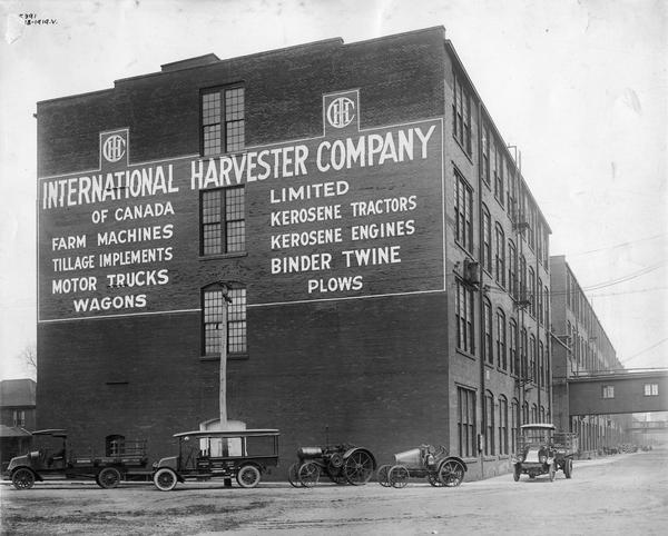 Various International Harvester trucks and tractors, including the Titan 10-20 and Mogul 8-16, parked in front of the company's Hamilton Works in Hamilton, Ontario, Canada.