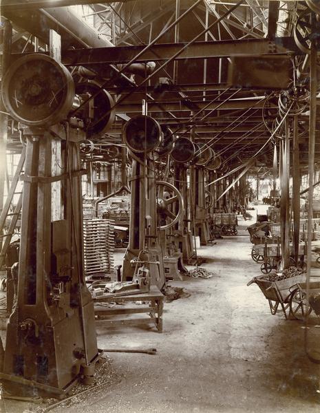 Rows of machinery, parts and tools in the forge shop at International Harvester's Hamilton Works in Hamilton, Ontario, Canada.