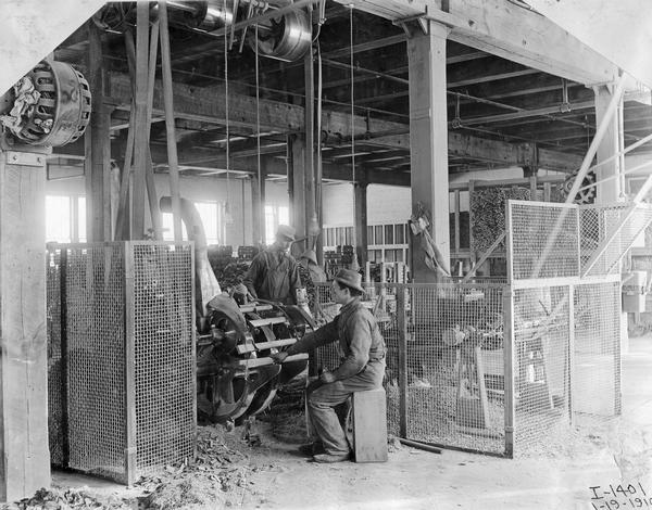 Workers cutting wooden spindles with a rotating saw at International Harvester's Weber Works in Auburn Park. The factory was owned by the Weber Wagon Company until 1904, when it was purchased by International Harvester.