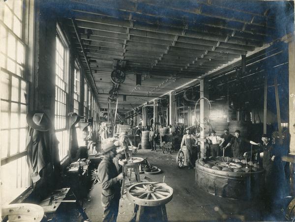 Workers assembling wagon and farm truck wheels the wood shop and wheel room of International Harvester's Weber Works in Auburn Park. The factory was owned by the Weber Wagon Company until 1904, when it was purchased by International Harvester.