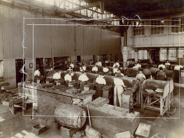Female employees working in the core room of International Harvester's Hamilton Works, Hamilton, Ontario, Canada. The photograph was marked by company staff for cropping.