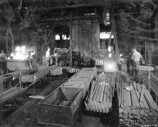 Workers manufacturing parts in a forge shop at International Harvester's McCormick Works. The McCormick Works was built by Cyrus McCormick in 1873 and became part of International Harvester in 1902. The factory was located at Blue Island and Western Avenues in the Chicago subdivision called "Canalport." It was closed in 1961.
