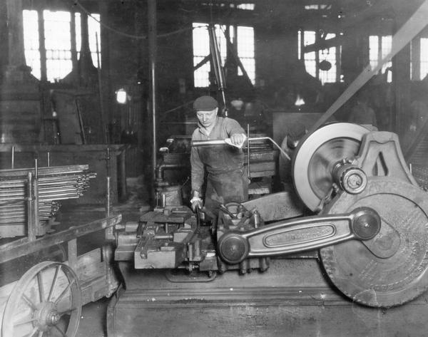 Worker forming steel components on a machine at International Harvester's McCormick Works. The factory was owned by the McCormick Harvesting Machine Company before 1902. It was located at Blue Island and Western Avenues in the Chicago subdivision called "Canalport."