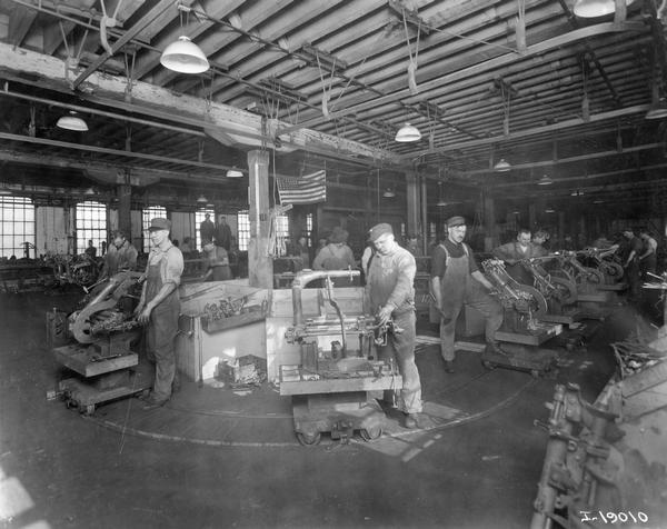 Workers assembling grain binders on an assembly line at International Harvester's McCormick Works. The factory was owned by the McCormick Harvesting Machine Company before 1902. It was located at Blue Island and Western Avenues in the Chicago subdivision called "Canalport."