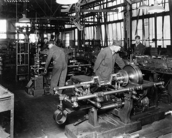 Factory worker tending to a crankshaft for a McCormick-Deering 10-20 tractor at International Harvester's Tractor Works.