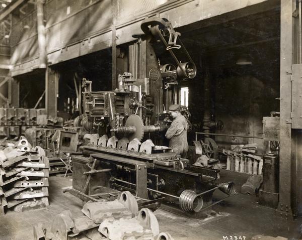 Worker machining castings at International Harvester's Milwaukee Works. The factory was owned by the Milwaukee Harvester Company before 1902.