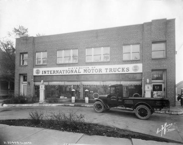 International service truck parked in front of an early International motor dealership owned by the Koval Motor Co.