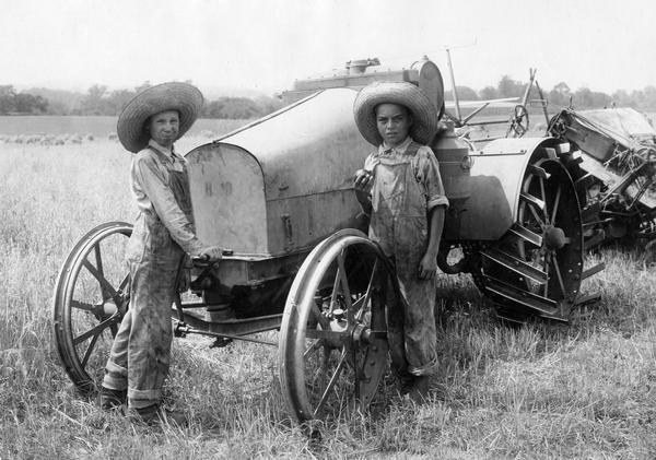 Two ten-year-old boys, Paul Lannom and William Smith, posing with an International 8-16 HP tractor and McCormick binder. The boys are the grandsons of "Daddy" Lannom of J.W. Lannom & Sons, near Nashville. This was the second year they harvested grain for their grandfather.