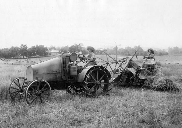 Two ten-year-old boys, Paul Lannom and William Smith, harvesting wheat with International 8-16 HP tractor and McCormick binder. The boys are the grandsons of "Daddy" Lannom of J.W. Lannom & Sons, near Nashville. This was the second year they harvested grain for their grandfather.