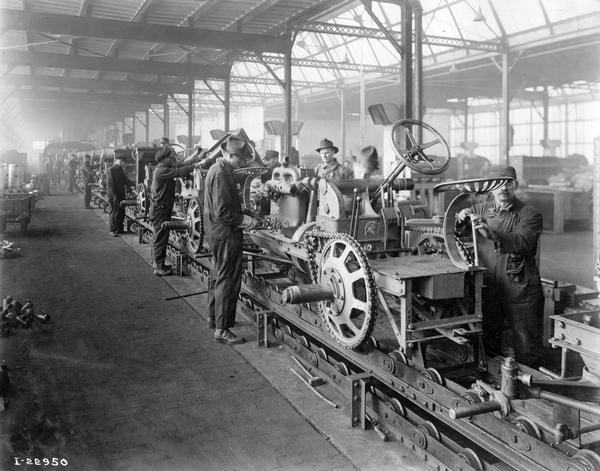 Workers tending to International 8-16 tractors on an assembly line at International Harvester's Tractor Works. The factory was located at 2600 West 1st Blvd.