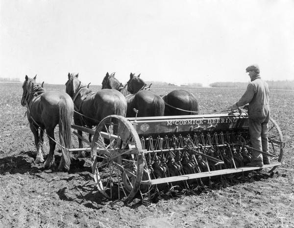 Mr. Shansky using a 20-run four-horse McCormick-Deering grain drill on his 300-acre farm in Transcona, Manitoba, Canada.