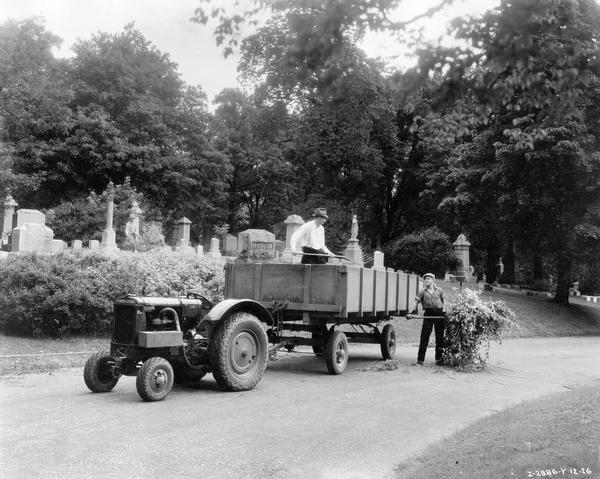 Workers tending the grounds of the Forest Home Cemetery using a McCormick-Deering I-12 tractor and wagon.