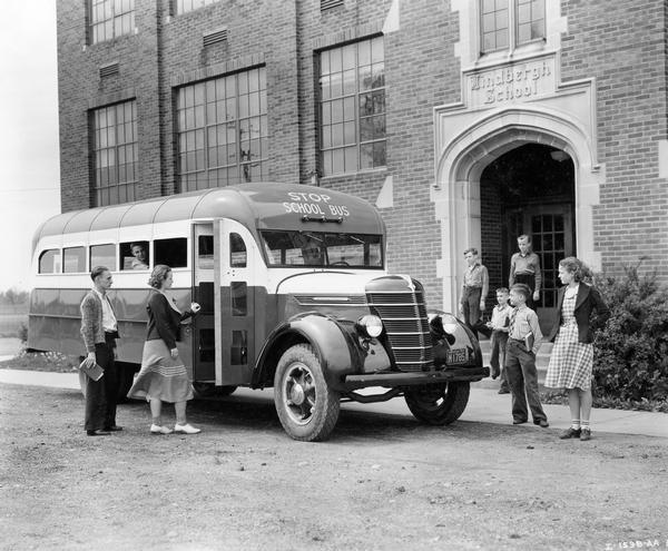 Students boarding an International D-30 school bus in front of the Lindbergh School. The bus featured a 19-foot Hicks body.