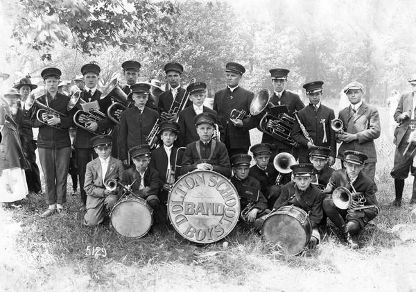 Outdoor group portrait of the Dolton School Boys Band. Original caption reads: "Dolton School Boys Band who furnished the music throughout the day for the Cook County School Festival held at Thornton, Illinois."