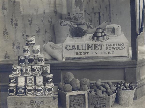 Storefront display of canned goods and vegetables.