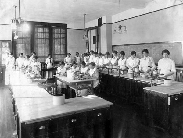 Female students in a home economics cooking class at the School of Agriculture in Olds, Alberta, Canada.