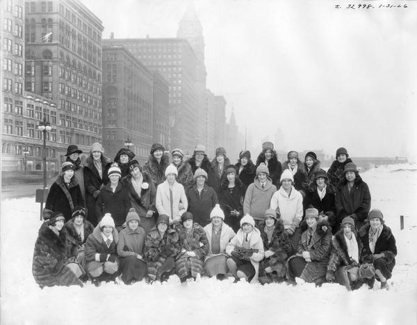 Group portrait of the members of International Harvester's women's choral society. The members worked in the company's general office. A woman in the front row is holding a small ukulele.