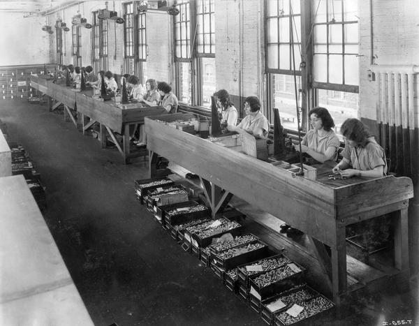 Female factory workers assembling parts at International Harvester's West Pullman Works.