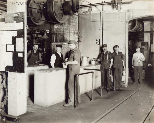 Workers waiting in line at a soup kitchen in International Harvester's Deering Works. The factory was owned by the Deering Harvester Company before 1902.