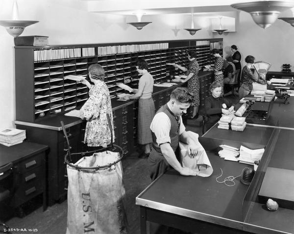 Men and women working in the 5th floor mail room of International Harvester's general office building.