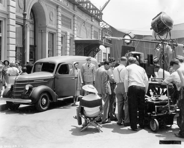 Cast and crew setting up a shot for the film "Youth Takes a Fling" starring Andrea Leeds and Joel McCrea. An International D-series panel truck was used in the scene.