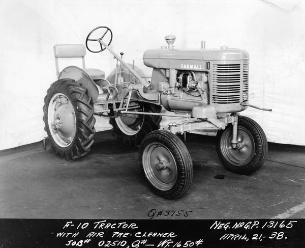 Engineering photograph of an experimental Farmall tractor "with air pre-cleaner" designated as model "F-10". Three-quarter view towards front right.
