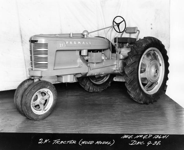 Engineering photograph of an experimental Farmall tractor (wood model) designated as model "2F". Three-quarter view towards left front.
