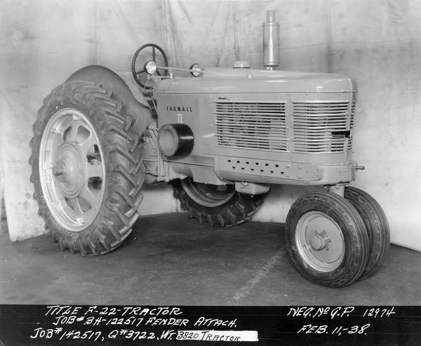 Engineering photograph of an experimental Farmall tractor with special fender attachment. The tractor was designated model "F-22". Three-quarter view towards right front.