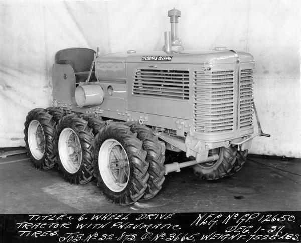 Engineering photograph of an experimental McCormick-Deering six wheel drive tractor with pneumatic tires. Three-quarter view towards front right.