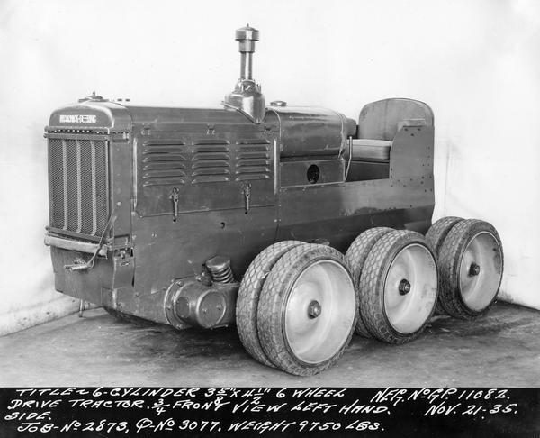 Engineering photograph of an experimental McCormick-Deering six wheel drive tractor with a six cylinder engine. Three-quarter view towards front left.