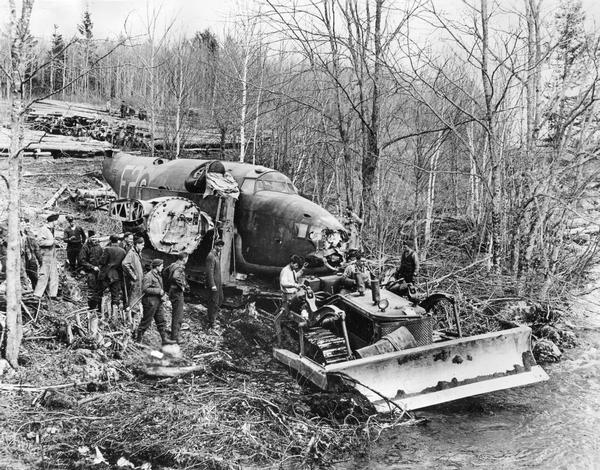 Royal Canadian Air Force men using an International TD-18 TracTracTor (crawler tractor) to salvage a B-34 bomber at Shell Camp Lake, Nova Scotia.
