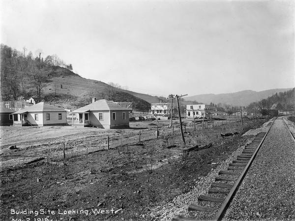 Residential building site near railroad tracks, looking west. Several houses are under construction. Benham was a "company town" created by International Harvester for the workers of the Wisconsin Steel Company. Wisconsin Steel was a subsidiary of International Harvester and operated coal mines at Benham.