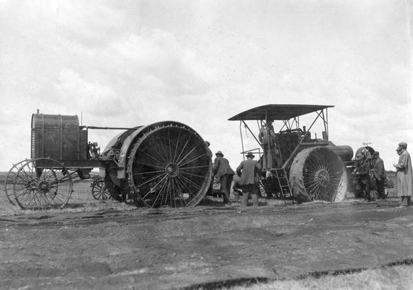 Men use a "Big Four" gas tractor to pull a Buffalo-Pitts tractor out of a hole at the Winnipeg tractor contest in Canada. The "Big Four" tractor was built by the Gas Traction Company of Minneapolis, Minnesota.