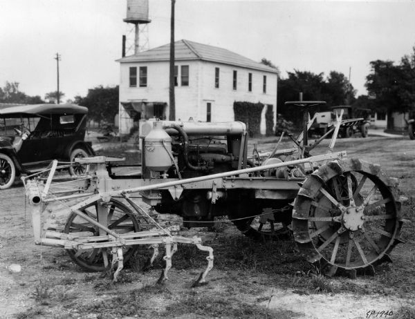 Engineering photograph of an experimental, reversible, early Farmall (?) tractor with attached cultivator.