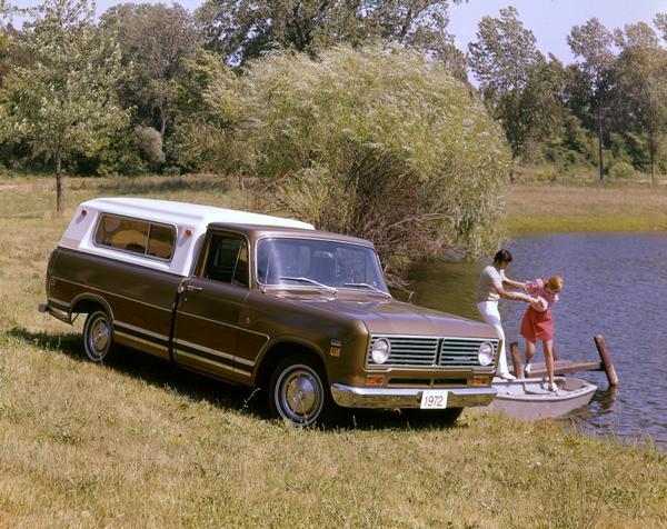 Color advertising photograph of an International Custom 1010 pickup with a young man and woman boarding a small boat at a dock on a rural pond.