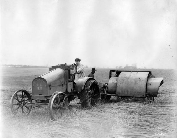 Man and woman harvesting hemp with an International 8-16 tractor and hemp gathering and bundling machine (binder?).