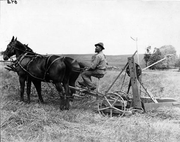 Farmer with horse-drawn McCormick Advance reaper built 1870-1871.