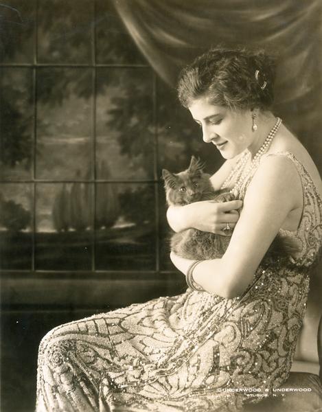 Studio portrait in front of a painted backdrop of Ganna Walska, Polish opera singer, holding a cat. At the time this picture was taken, Ganna Walska was the "bride of Alexandre Smith Cochran," according to the <i>Chicago Sunday Tribune</i> of January 16, 1921. Later she was divorced, and married Harold Fowler McCormick in August, 1922.