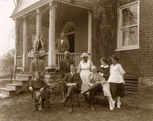 Outdoor group portrait of the Harold Fowler McCormick family, friends and servants at Walnut Grove. Left to right (seated): Kathleen (Mrs. Rush) Searson, Fowler McCormick, Harold F. McCormick, Mathilde McCormick (leaning on Harold). Left to right (standing): (J.) Rush Searson, "Old Henry," "Julia the cook," Julia Mangold. On porch (L to R): Muriel McCormick and Howard Colby.