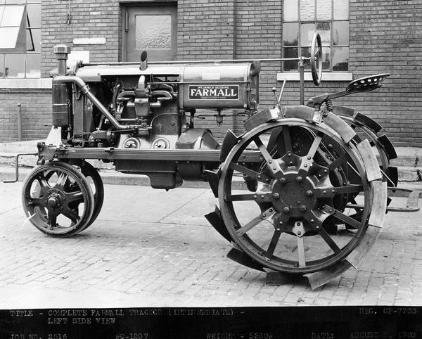Engineering photograph of experimental Farmall tractor. Original caption reads: "Complete Farmall tractor (intermediate) - left side view."