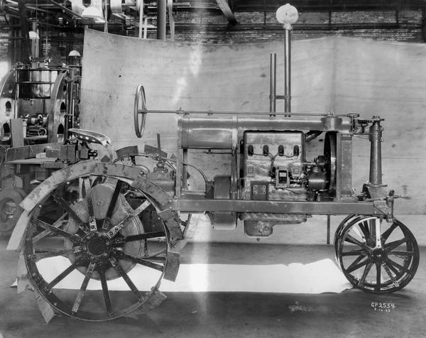 Engineering photograph of an experimental Farmall tractor. Right side view.