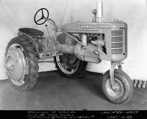 Engineering photograph of experimental McCormick-Deering Farmall B tractor with 32 inch rear wheels. Three-quarter view towards right front.