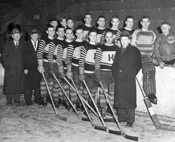 Group portrait of a hockey team from International Harvester's Hamilton Works in Hamilton, Ontario, Canada.