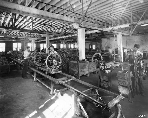 Factory workers assembling hay rakes at International Harvester's Rock Falls Works. The factory was owned by the Keystone Manufacturing Company until it was purchased by International Harvester in 1904. The factory was known as the "Keystone Works" before 1920.